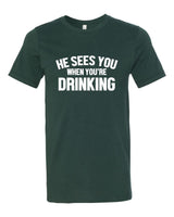 HE SEES YOU WHEN YOU'RE DRINKING BOUTIQUE TEE